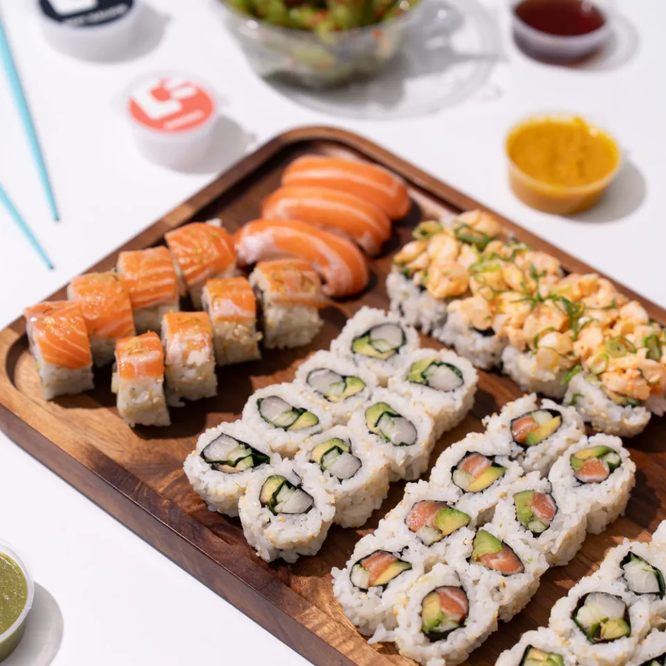 Happy Rice catering platter of assorted sushi rolls and nigiri with sauces