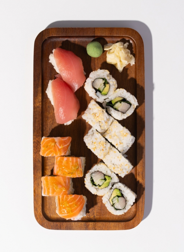 Keep Calm Box with amberjack avocado rolls, salmon on salmon and tuna nigiri on a wooden tray