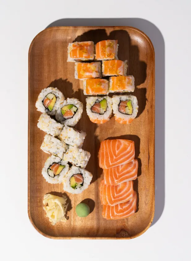 Heart & Mind Box with salmon avocado rolls and salmon sashimi on a wooden tray